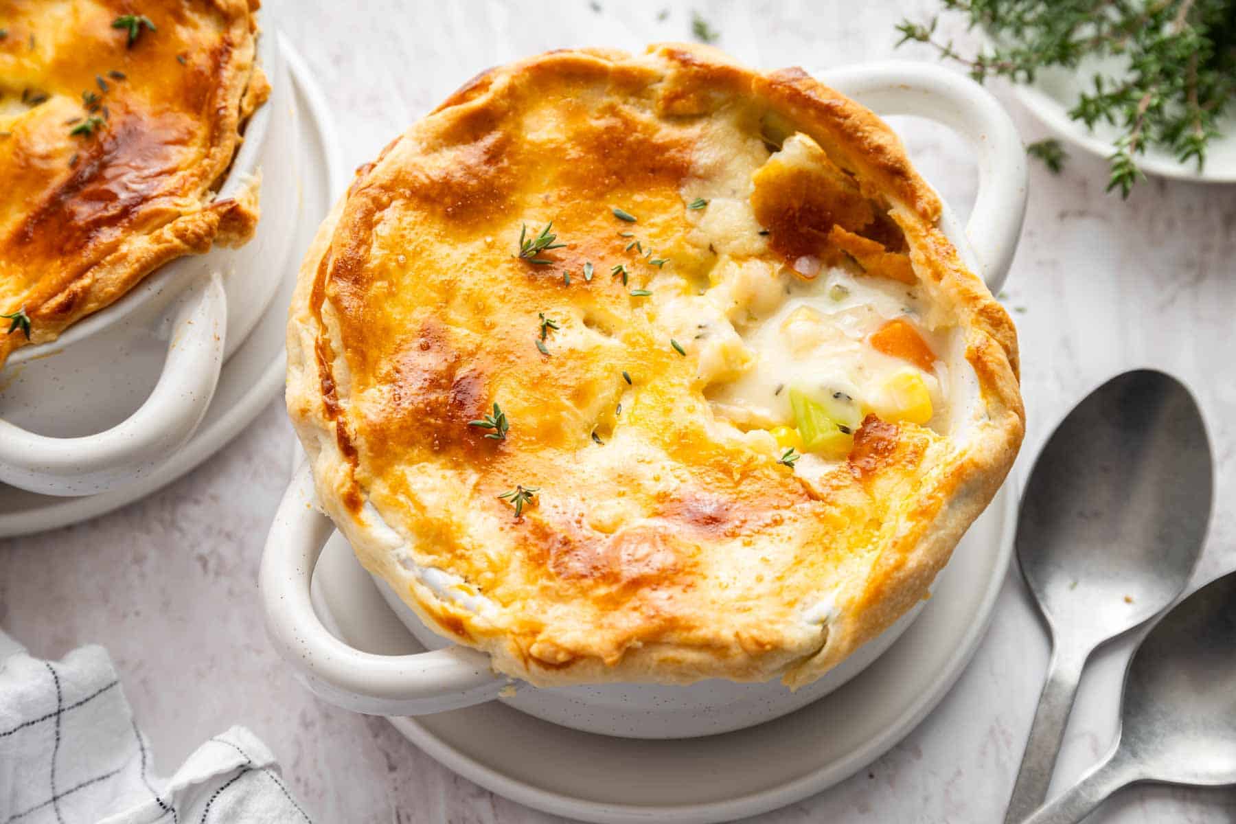 Horizontal image of chicken pot pie for two with golden brown crust.