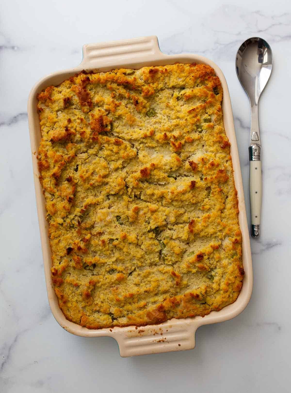 Overhead vertical image of southern cornbread dressing in 9x13 inch pan.