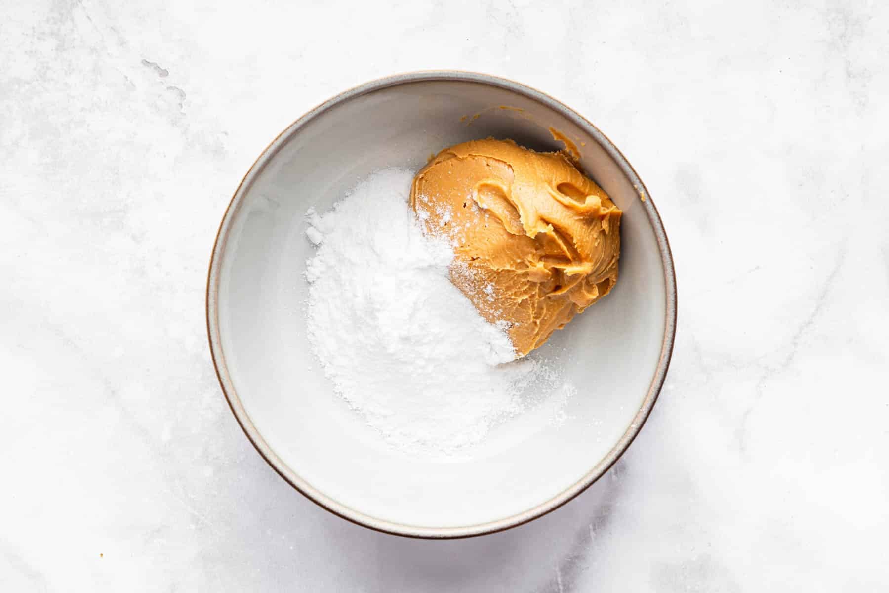 Bowl of peanut butter and powdered sugar together.