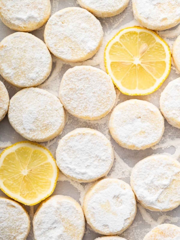 Vertical macro image of sliced lemon meltaways with lemon slices in between.