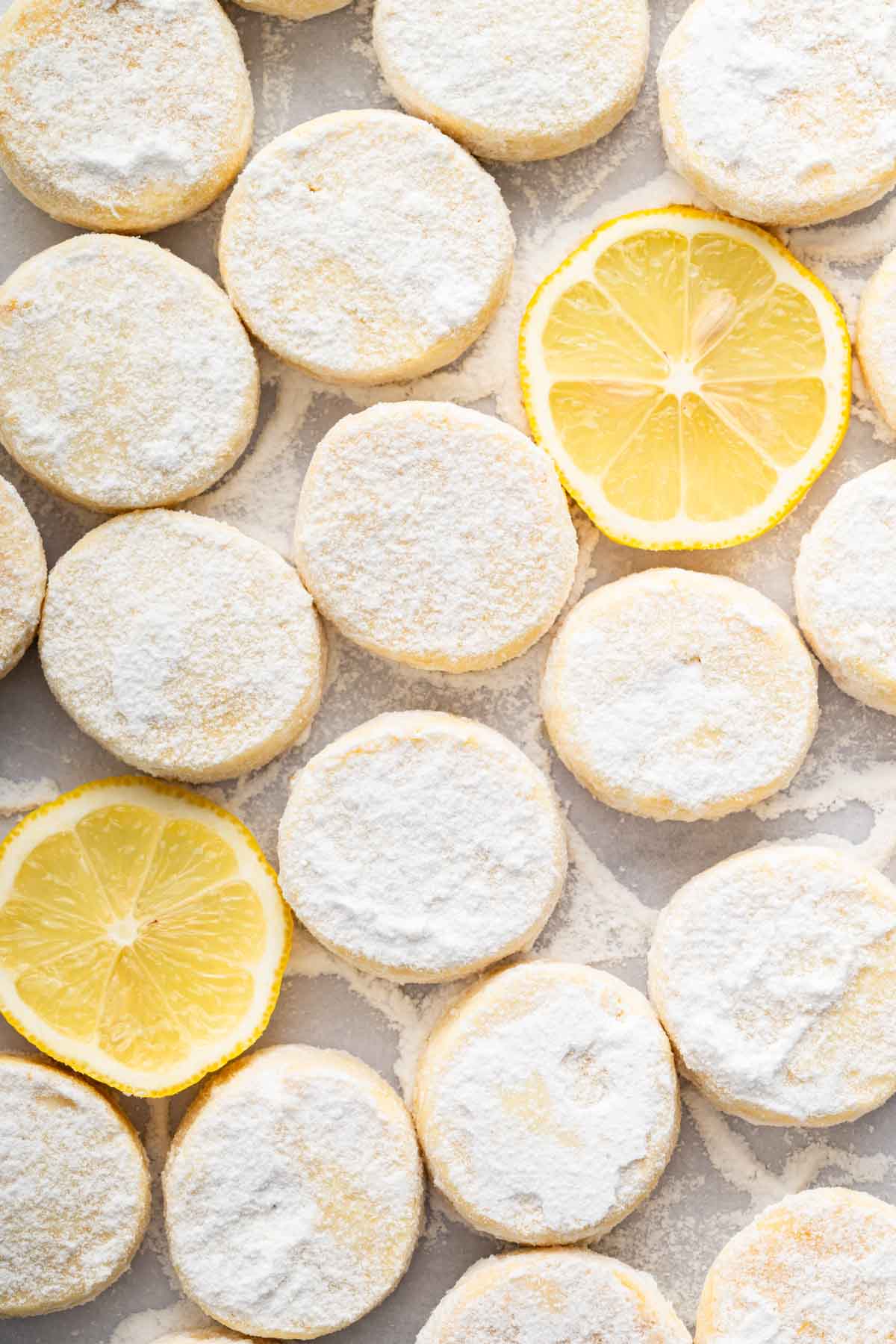 Closeup macro image of lemon meltaways with lemon slices next to them.