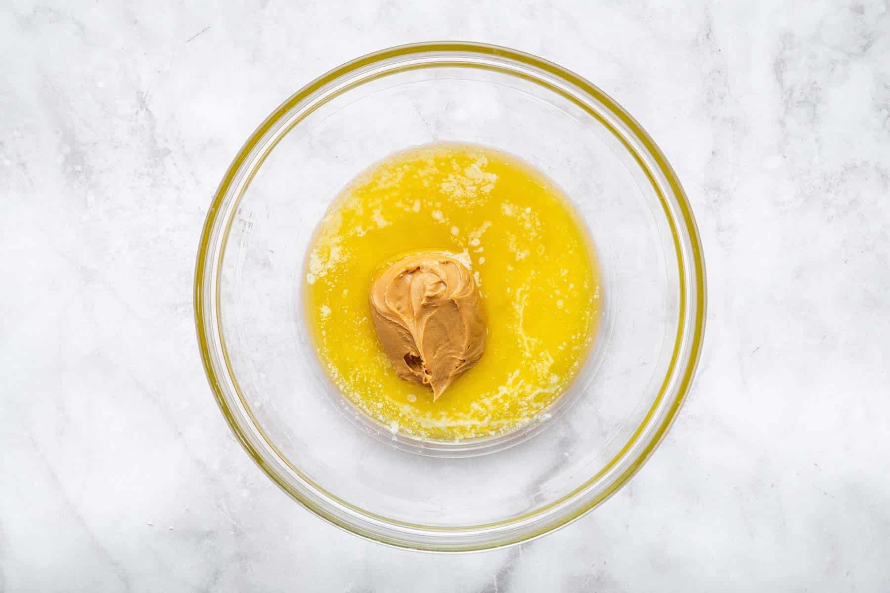 Clear glass bowl with melted butter and brown mixture.