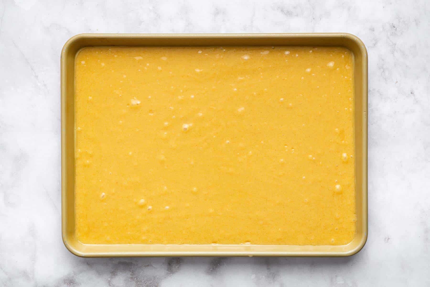 Brown liquid batter in rectangular pan.