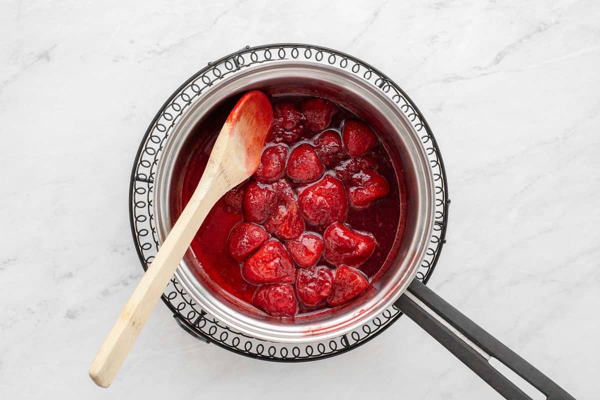 Cooked strawberries in a pan.