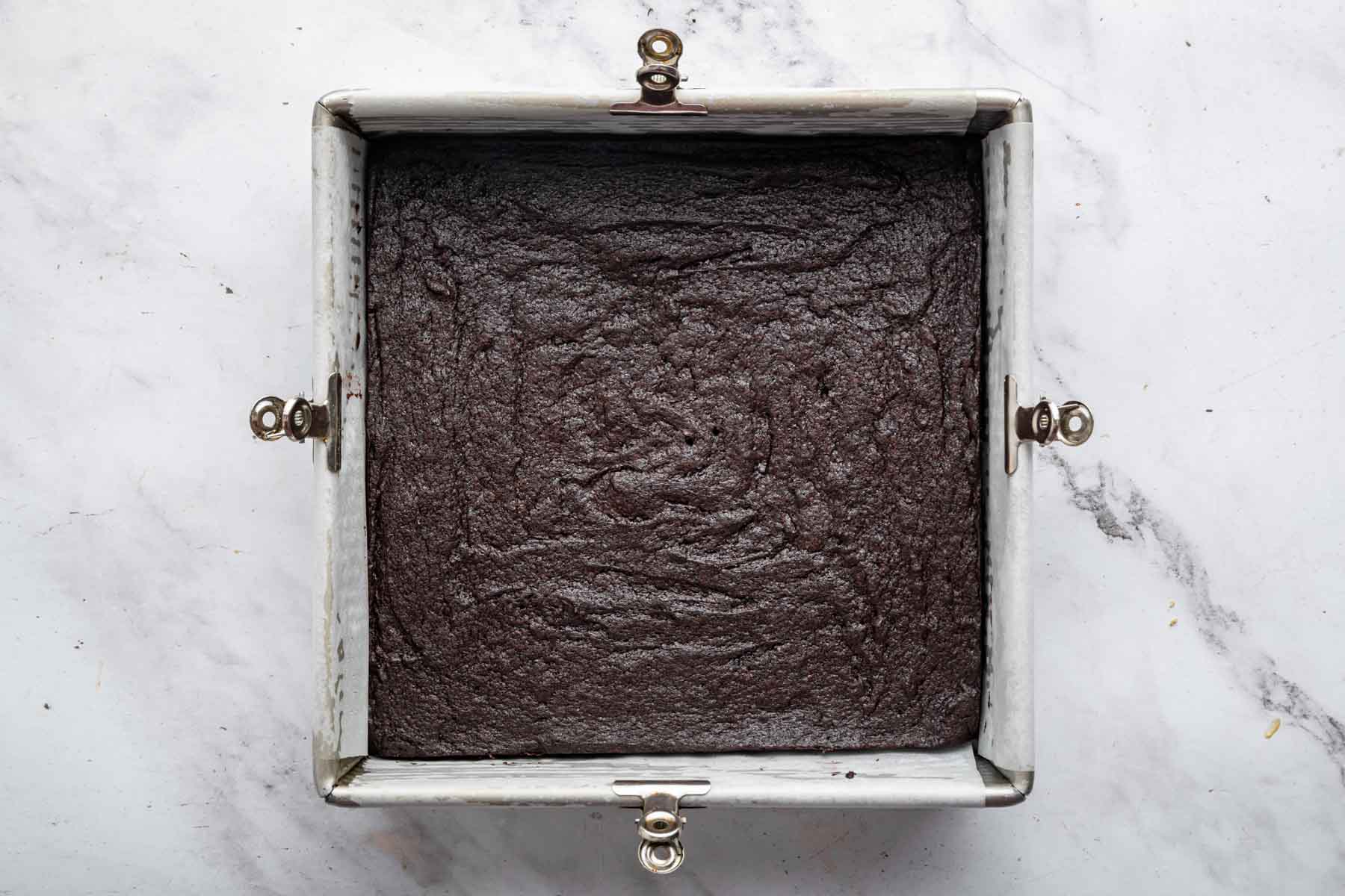 Freshly baked brownies in a square pan.