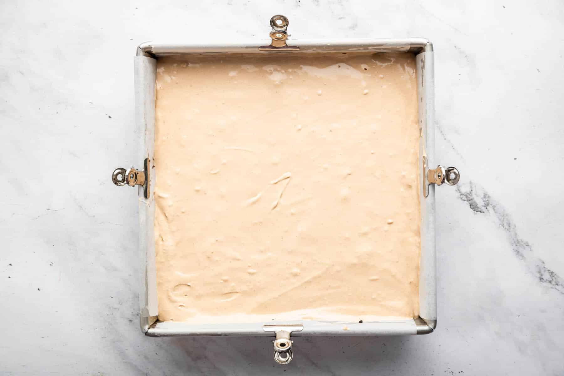 Light brown mousse in square pan.