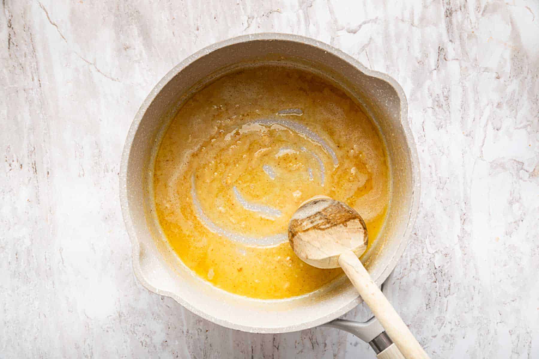 Butter and flour roux in small saucepan with wooden spoon.