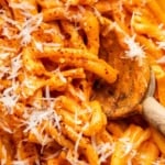 Macro image of vodka pasta with grated Parmesan on top.