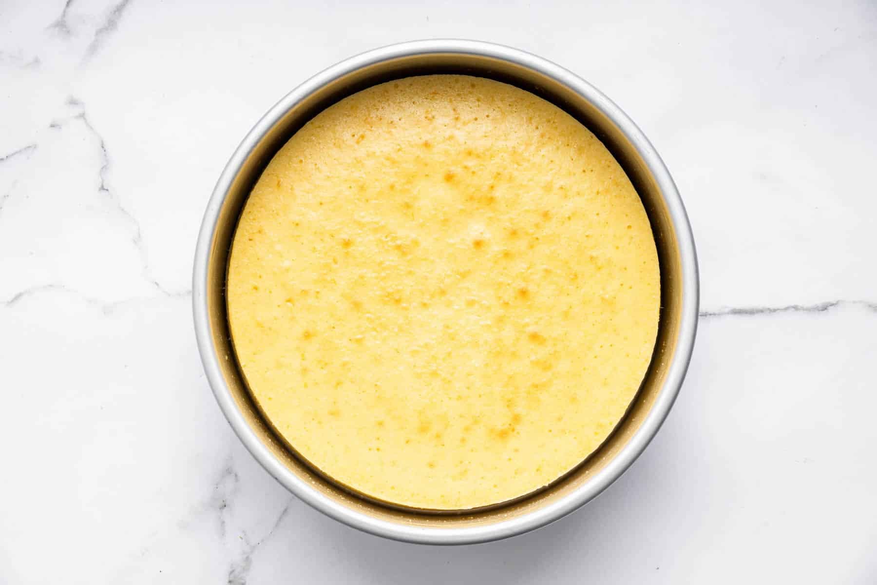 Round yellow cake in pan.